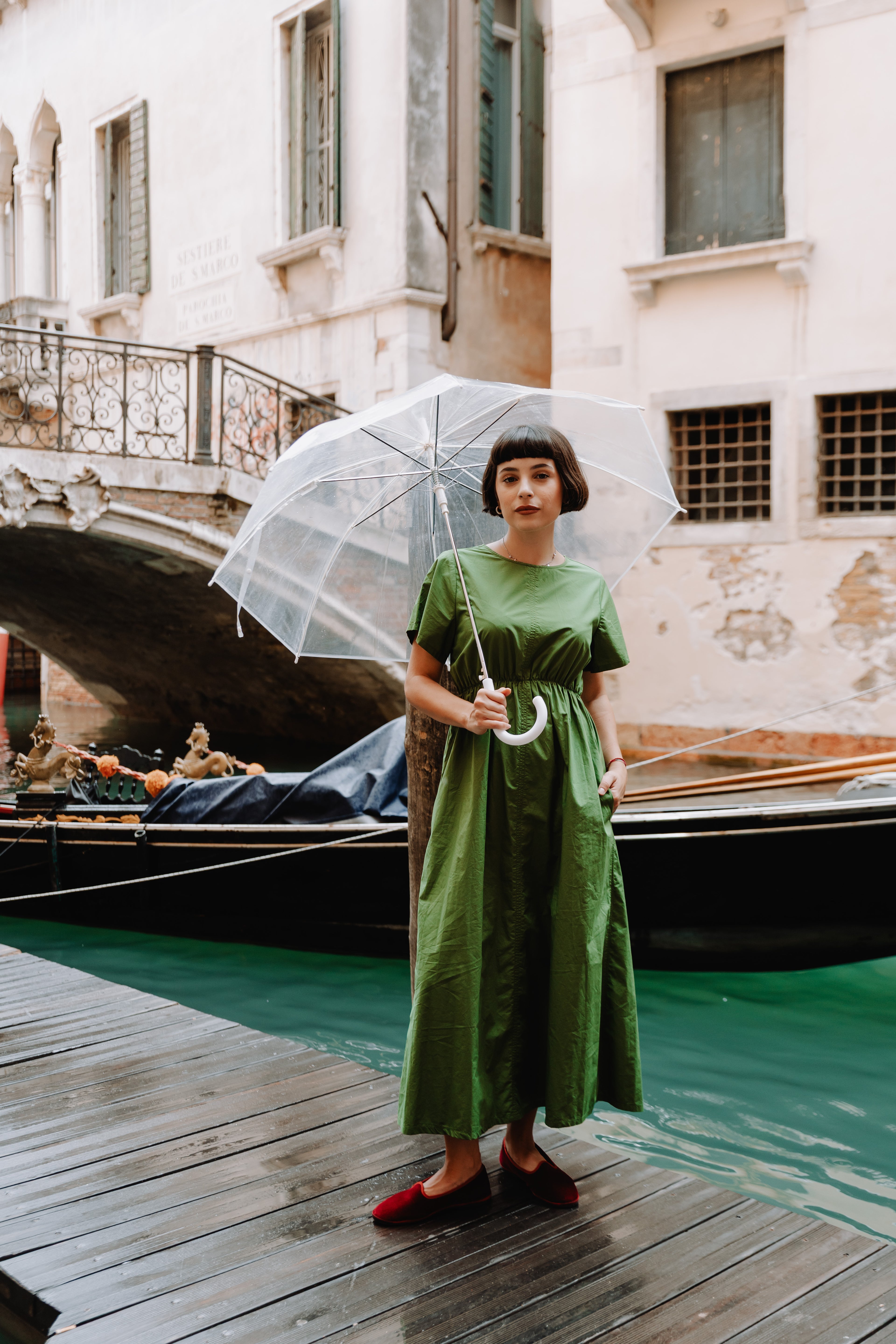 Handcrafted Gondolina Dogale flats in red velvet, featuring authentic Venetian design, worn by model