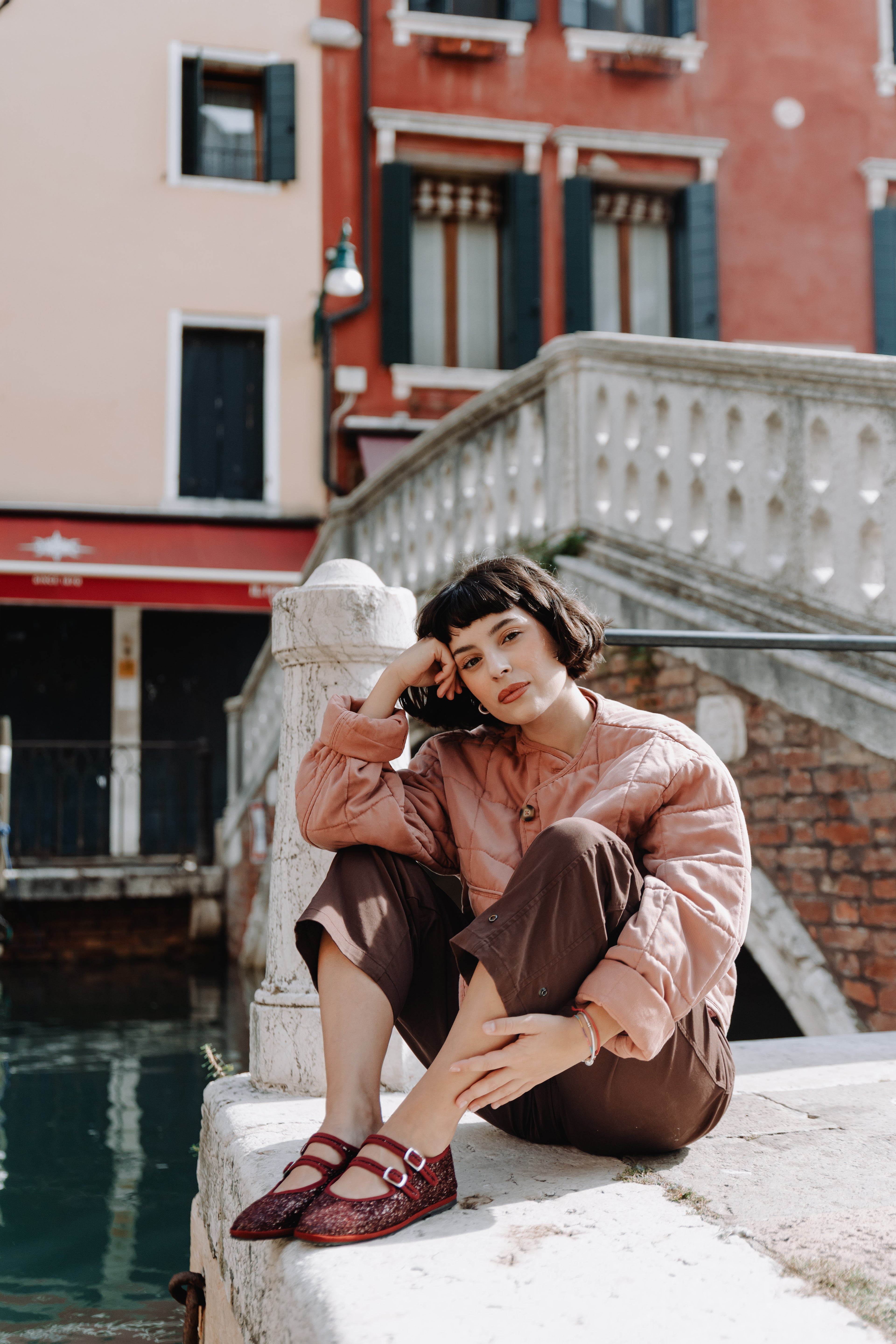 Handcrafted Gondolina Giudecca Mary Jane in burgundy glitter, featuring authentic Venetian design, worn by model