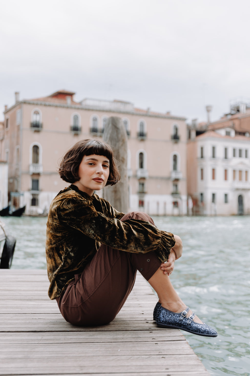 Handcrafted Gondolina Gran Canale Mary Jane in blue glitter, featuring authentic Venetian design, worn by model