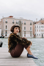 Handcrafted Gondolina Gran Canale Mary Jane in blue glitter, featuring authentic Venetian design, worn by model