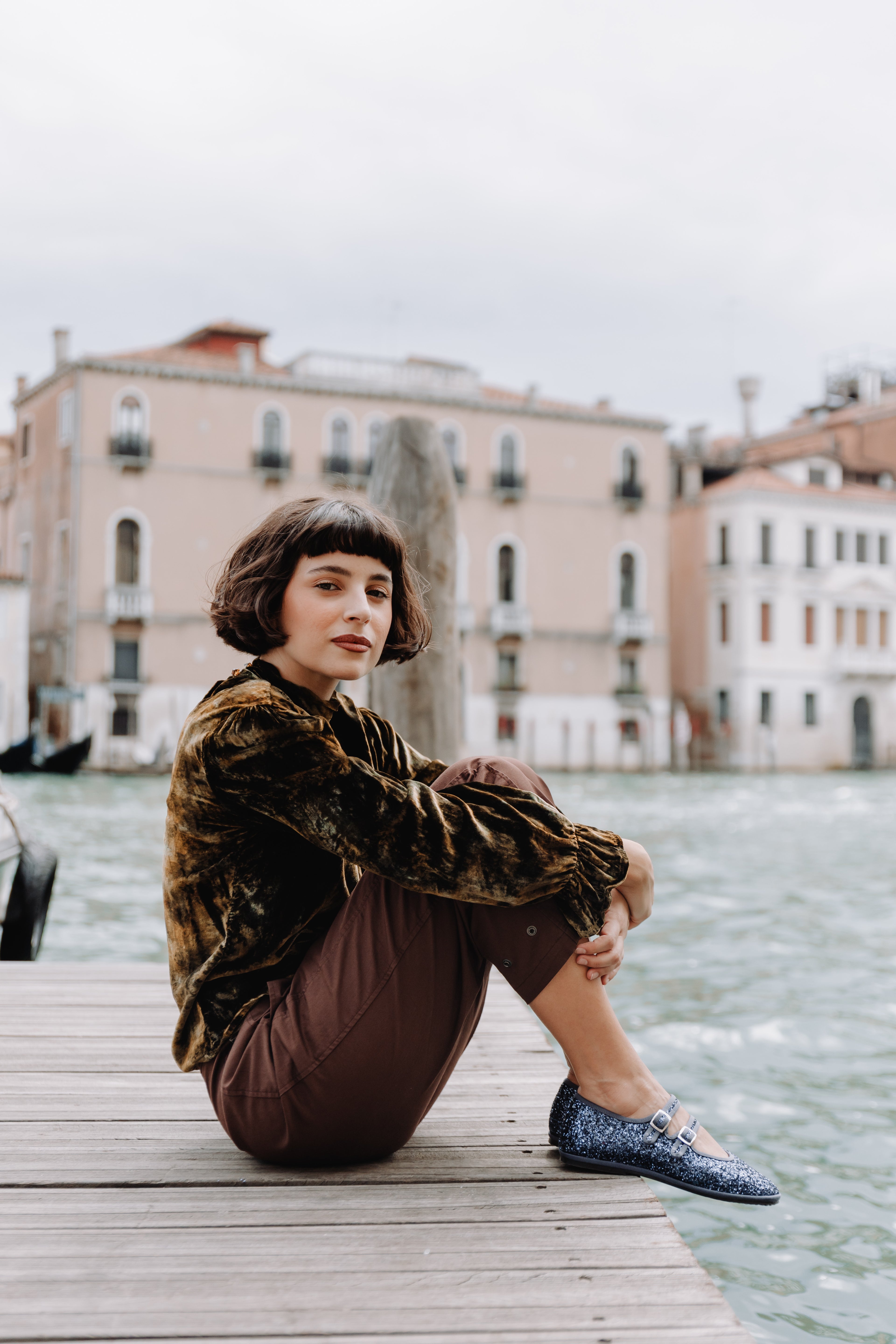 Handcrafted Gondolina Gran Canale Mary Jane in blue glitter, featuring authentic Venetian design, worn by model