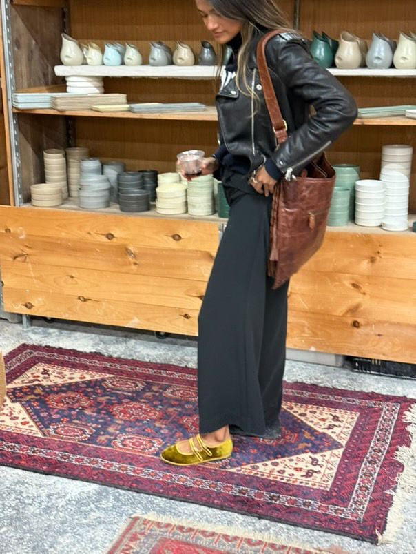 Handcrafted Gondolina Nina Mary Jane in yellow silk velvet, featuring authentic Venetian design, worn by model